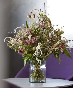 Høj og luftig buket med blandede sommerblomster i lyserøde og lilla farver